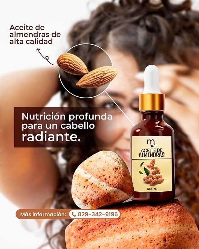 Flacon ambré de 100 ml d'huile d'amande avec compte-gouttes doré, orné d'amandes naturelles et de pierres décoratives. En arrière-plan, une femme aux cheveux bouclés sourit en se caressant les cheveux. Le texte souligne « Huile d'amande de haute qualité » et « Nourrit en profondeur pour des cheveux éclatants ».